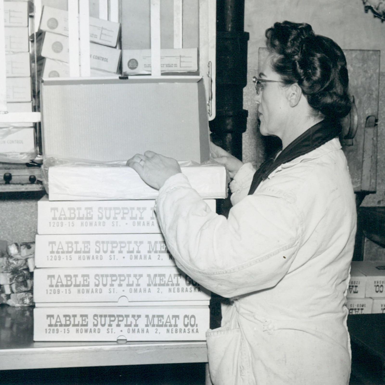 Woman packing an Omaha Steaks shipment